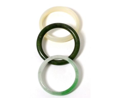 A jade bangle, a nephrite bangle and another bangle (3) 124.91g gross
