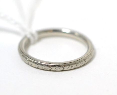 A floral engraved band ring, finger size K, stamped 'PLATINUM'3.8g gross