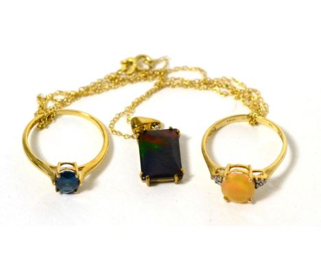 A 9 carat gold ammolite pendant on chain, a 9 carat gold opal and diamond ring, finger size S, a 9 carat gold ruby half hoop 