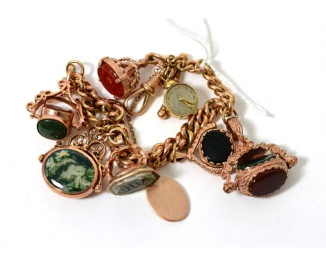 A 9 carat gold charm bracelet with five swivel fobs, a seal fob, a pendant and a 9 carat gold alarm clock charm 60.2g gross