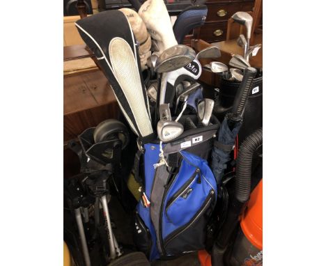 TWO GOLF HOLDALLS OF VARIOUS SETS OF GOLF CLUBS AND A PRO LIGHT CADDY