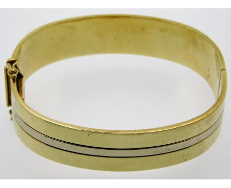 A two colour, 9ct gold bangle with clasp, internal diameter 60.25mm, 28.2g
