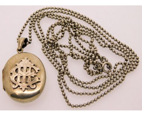 An antique white metal locket, tests as silver set with a 57in 0.800 silver beaded muff chain, 39g