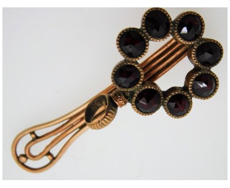 A 19thC. rose yellow coloured metal pocket clip brooch with loop for watch or chatelaine, tests as 10ct gold, set with garnet