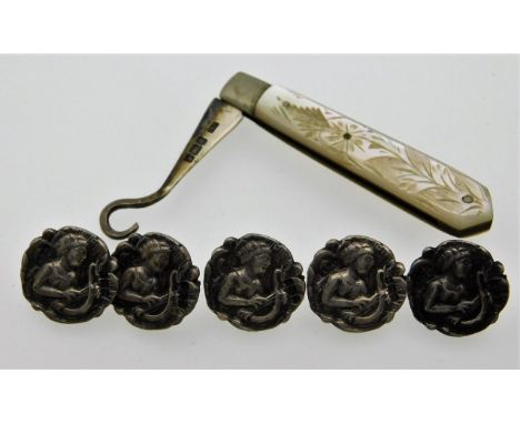 A 1907 C.W. Fletcher Sheffield silver &amp; mother of pearl button hook twinned with five silver (tested) buttons depicting a