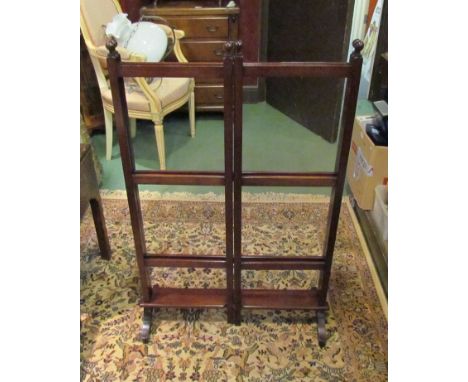 An Edwardian mahogany double gate action nine bar towel rail, the turned finials over sledge feet joined by a flat stretcher 