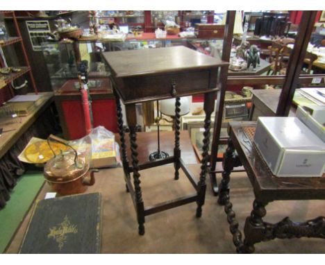 A circa 1910 oak lamp table the single frieze drawer over swash turned legs joined by stretchers, 71cm tall