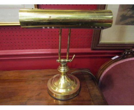 A brass adjustable desk lamp