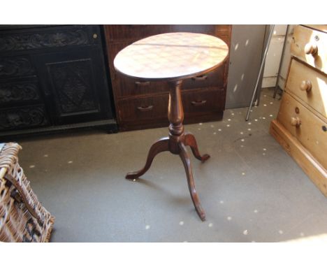 A mahogany tilt top table raised on tripod base