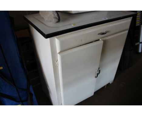 An enamel top kitchen cabinet