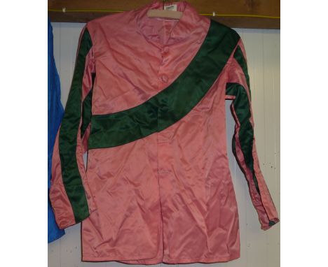 Pink horse racing silks/colours with dark green sash (cap missing) Jacket marked Gibson Saddlers Ltd Newmarket England. Also 