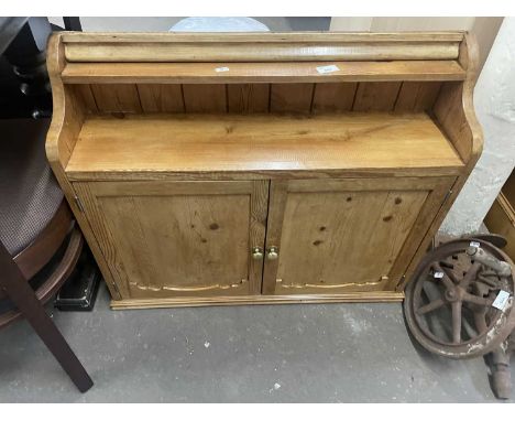 Wall mounted pine cabinet with two doors with brass handles and shelf below