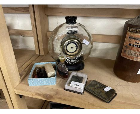A novelty French clock/decanter together with miniature perfumes, lighter etc