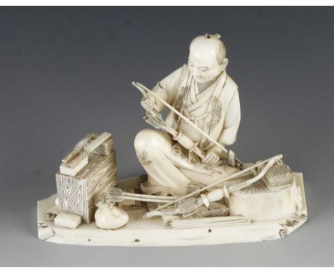 A 3" ivory okimono of a fletcher or bow and arrow maker with his tools