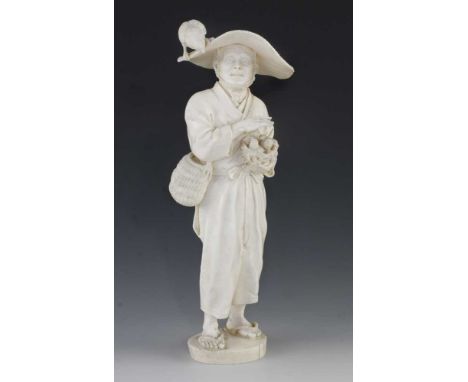 A 10" ivory okimono of a man carrying a nest with two fledglings and the concerned mother bird on his hat