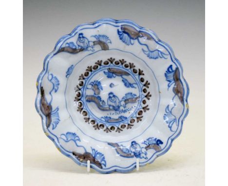 Late 17th or early 18th Century Delft / Delftware buckle plate, decorated in blue and manganese with a figure in a landscape,