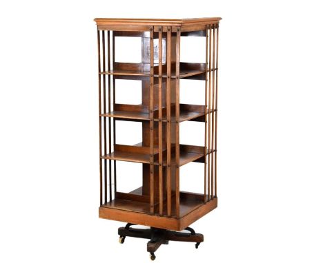 Early 20th Century revolving mahogany bookcase, of typical form with four sectioned tiers united by spars, stencilled label '