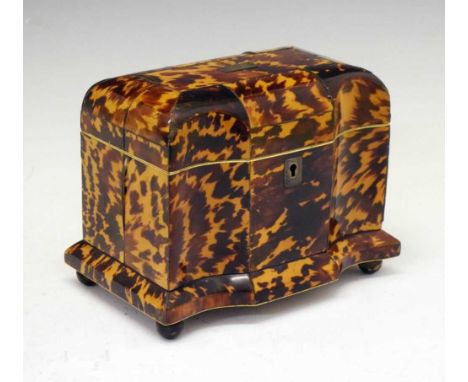 Second quarter 19th Century tortoiseshell tea caddy, pewter-strung, of arc-en-arbalete fronted form, the hinged cover centred
