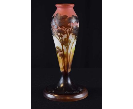 Gallé – Cameo glass vase, of tapered form on spreading foot, brown glass overlaid on opaque body, cut with landscape decorati
