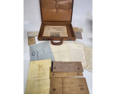 A vintage tan briefcase containing Lloyds Bank cheque books dating mid to late 1930's, a driving licence, issue number 243941