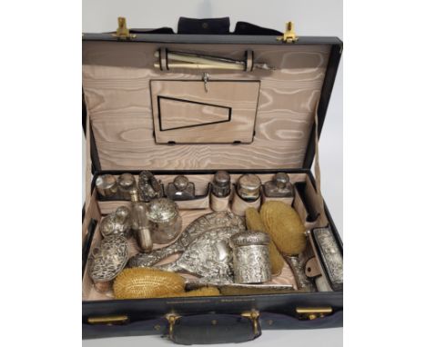 A ladies/ gentleman's travelling set monogramed (O.A.T) on the leather case, stamped the Goldsmiths and Silversmiths Company 