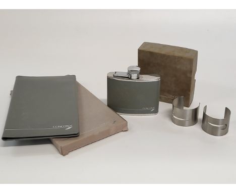 A collection of Concorde memorabilia including a boxed grey calf leather wallet, a boxed stainless steel hip flask with funne