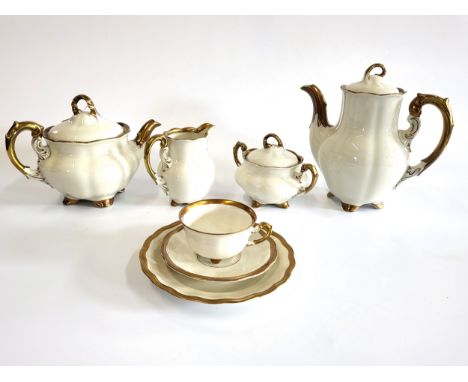 A German Koenigszelt porcelain Charlotte tea and coffee service in cream with gilt borders. (37)