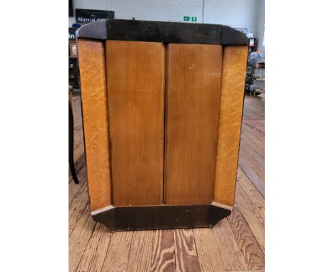 A 1930's drinks cabinet with two doors and glass shelf, and including a bottle opener. Veneer chipped and damaged on sides an