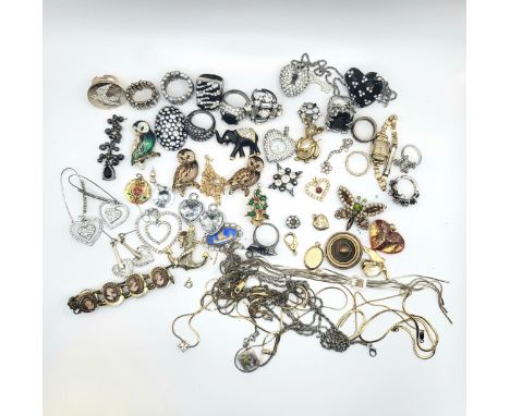 Mixed costume jewellery including black and white enamel rings, and pendants, rings, brooches, earrings and watches.