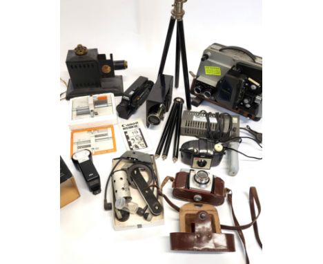 A collection of vintage cameras including a 1968 Raynox S 505 8mm film camera, Cocorico Patheorama Magic Lantern 1924, a Cano