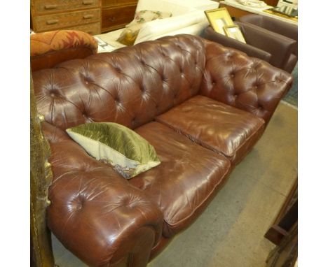 A Chesterfield sofa upholstered in brown button leather