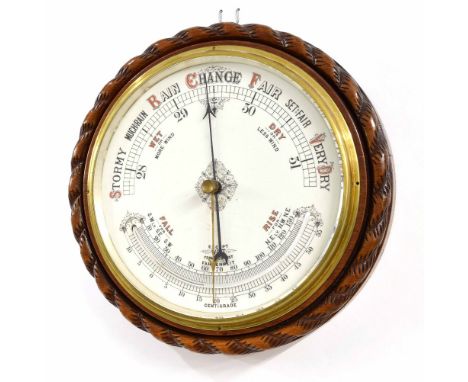 Oak cased circular wall barometer with thermometer, the 10" dial within a carved rope twist surround
