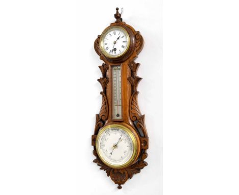 Oak cased aneroid barometer with clock and thermometer, the principal 5" barometer dial within a pierced foliate carved case 