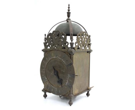 Reproduction brass lantern clock, the 6.5" brass chapter ring enclosing a foliate engraved centre, surmounted by pierced foli