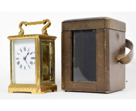 Carriage clock striking on a gong, the white dial with Roman numerals, within a brass corniche case, 5.5" high; with Morocco 