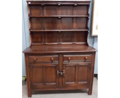 Ercol Elm dresser, the raised back with three shelves, the base with two drawers and two cupboard doors, width 48'