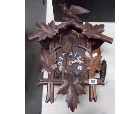 Black Forest cuckoo clock with two train movement, the case surmounted by a bird, height 17.5'.