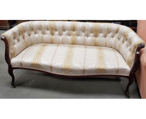 Edwardian Walnut framed salon two seat settee with button back foliate damask upholstery, the scroll arms with leaf carving a