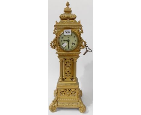 Gilt metal two train time piece, the case ornately carved as a tower clock, height 20.75'