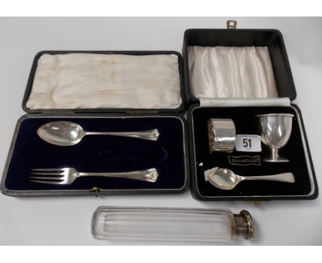 Cased silver three piece Christening set comprising egg cup, spoon and napkin ring, together with a cased desert fork and spo