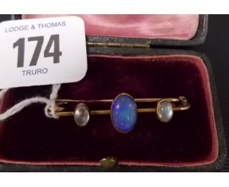 18ct gold bar brooch set with an opal and two moonstone cabachons, weight 3.4gms approx.