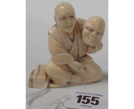 19th Century Japanese ivory Okimono, carved as a seated entertainer with mask and piano accordion at his side, signed, height