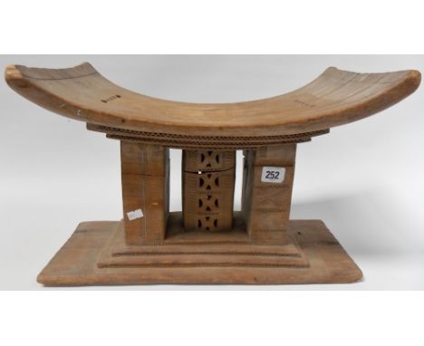 African tribal stool or headrest with geometric carved and pierced decoration, width 17'.