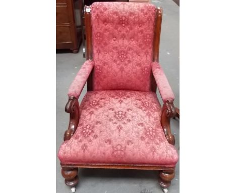 Victorian Walnut framed gentlemans upholstered library chair, the arms with c-scroll carved support and on turned fore legs w