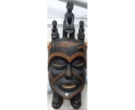 Huge African tribal mask, scratch carved with 3 birds to the forehead surmounted by 3 carved figures playing drums and 2 upsi