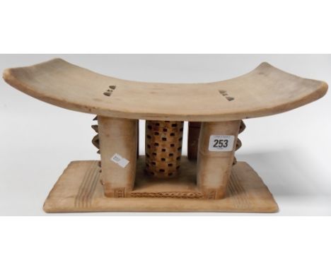 African tribal stool or headrest with geometric carved and pierced decoration, width 13'.