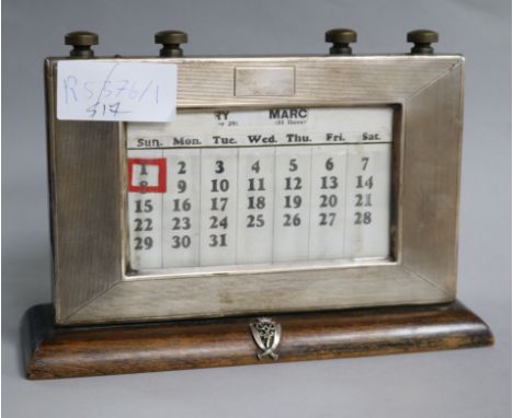 An engine turned silver mounted desk calendar with Gurkha crest.