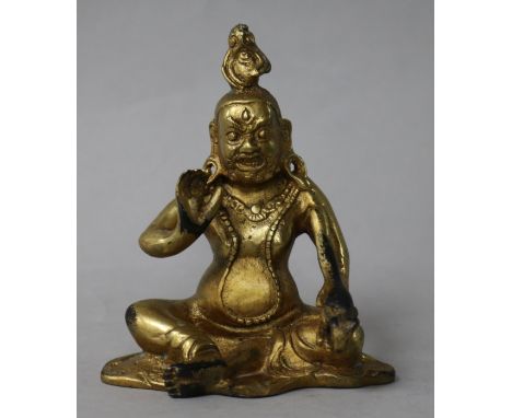 A gilt bronze seated figure of a deity