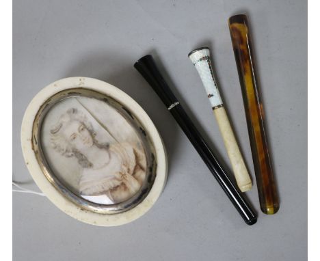 An ivory snuff box and three cheroot holders