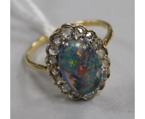 A yellow metal, opal and diamond oval cluster ring, size O.